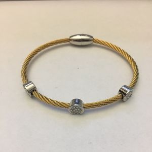 Raised crystals on cable magnetic bracelet.